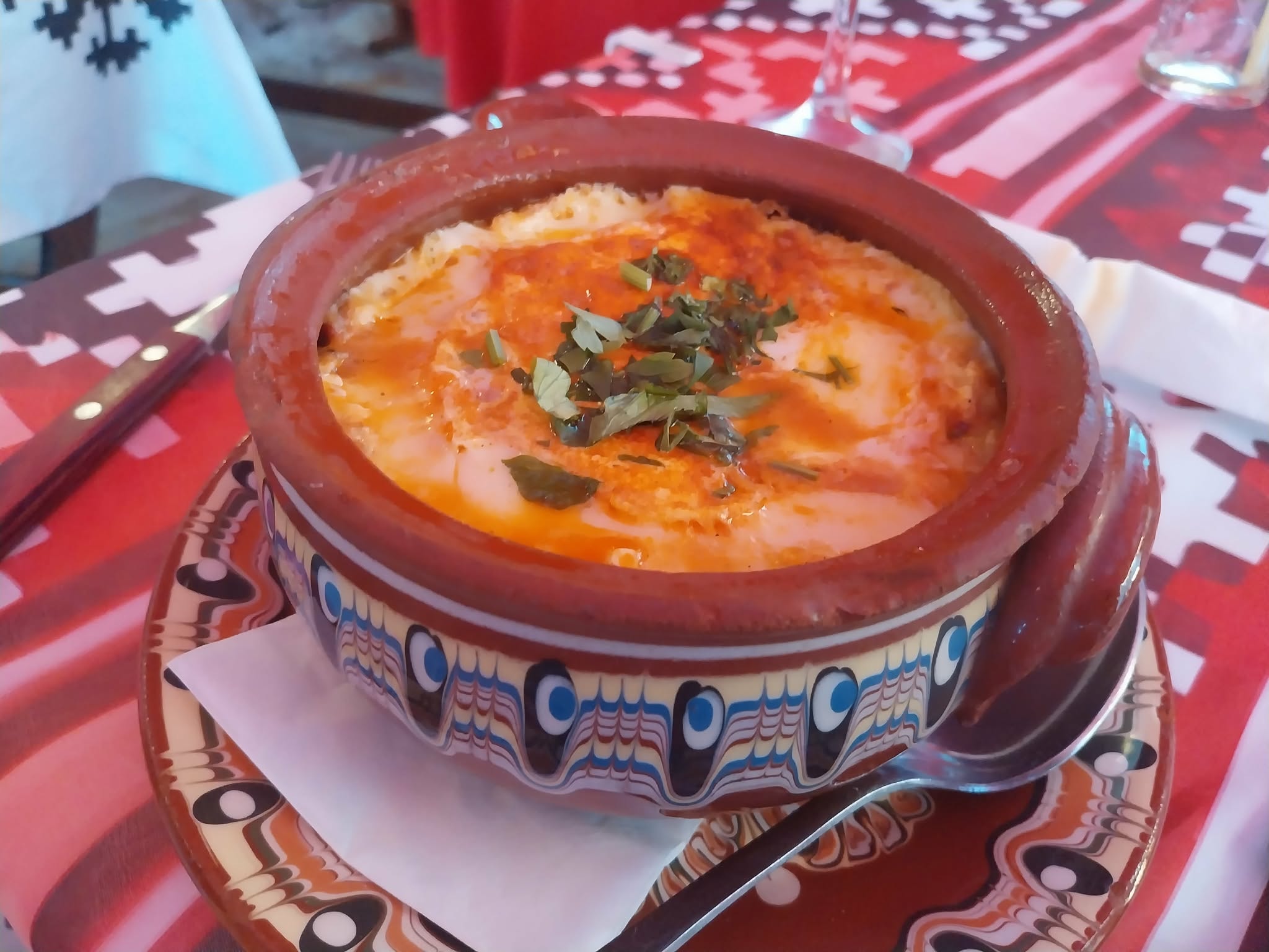 Bulgarian clay pot kavarma dish on rustic wooden table